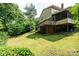 Spacious backyard with grass, a large deck, and the home's exterior at 5516 Northwood Dr, Hickory, NC 28601