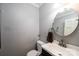 Cozy half bathroom featuring a round mirror and modern sink at 5516 Northwood Dr, Hickory, NC 28601