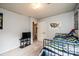 Bedroom with blue and striped bedding, TV, and colorful map of the USA at 5516 Northwood Dr, Hickory, NC 28601