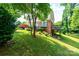 Exterior view of the home displaying the yard, brick foundation, siding, and small deck at 5516 Northwood Dr, Hickory, NC 28601