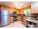 Well-lit kitchen with wood cabinets, stainless steel appliances, granite countertops, and hardwood floors at 5516 Northwood Dr, Hickory, NC 28601