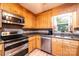 Stylish kitchen with stainless steel appliances, wood cabinets, and a bright window above the sink at 5516 Northwood Dr, Hickory, NC 28601
