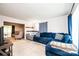 Cozy living room featuring plush blue sectional couch, neutral walls, and carpeted floors at 5516 Northwood Dr, Hickory, NC 28601