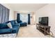 Bright living room with a plush blue sofa, large windows, neutral walls and carpets at 5516 Northwood Dr, Hickory, NC 28601