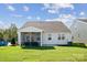 A view of the home's backyard featuring a covered patio, lush green lawn, and attractive exterior at 6520 Alanbrook Rd, Charlotte, NC 28215