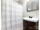 Functional bathroom featuring a white shower curtain and dark vanity at 7012 Somerset Springs Dr # E, Charlotte, NC 28262