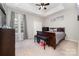 Bedroom with tray ceiling, large window with view, and dark wood furnishings at 7012 Somerset Springs Dr # E, Charlotte, NC 28262