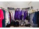 Walk-in closet features shelving and clothing racks for ample storage space at 7012 Somerset Springs Dr # E, Charlotte, NC 28262