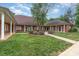 Charming brick home featuring manicured lawn and sidewalk leading to the entrance at 7012 Somerset Springs Dr # E, Charlotte, NC 28262