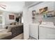 Convenient laundry room includes a washer, dryer, and storage shelving at 7012 Somerset Springs Dr # E, Charlotte, NC 28262