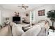 Cozy living room features a comfortable sectional sofa and stylish ceiling fan at 7012 Somerset Springs Dr # E, Charlotte, NC 28262