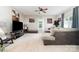 Bright living room featuring a ceiling fan, neutral walls, and a comfortable sectional sofa at 7012 Somerset Springs Dr # E, Charlotte, NC 28262