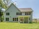 The home's back exterior offers a covered porch and a spacious yard at 7108 Hambright Rd, Huntersville, NC 28078