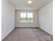 Sun-filled bedroom with dual windows, offering a scenic view of the neighborhood at 7108 Hambright Rd, Huntersville, NC 28078