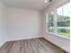 Bright bedroom with large windows and hardwood floors, offering ample natural light at 7108 Hambright Rd, Huntersville, NC 28078