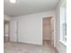 Bright bedroom with an open closet doorway, featuring soft, neutral carpeting and white walls at 7108 Hambright Rd, Huntersville, NC 28078
