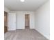 Bright bedroom with an open closet doorway, featuring soft, neutral carpeting and white walls at 7108 Hambright Rd, Huntersville, NC 28078