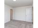 A spacious bedroom has neutral carpet, and white walls, offering a bright and airy feel at 7108 Hambright Rd, Huntersville, NC 28078