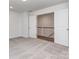 Neutral bedroom featuring an open door leading to the hallway, creating an inviting space at 7108 Hambright Rd, Huntersville, NC 28078