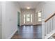 Bright foyer with hardwood floors, white trim, and a glass front door, offering a welcoming entrance at 7108 Hambright Rd, Huntersville, NC 28078