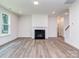 Spacious living room with a cozy fireplace, hardwood floors, and ample natural light, creating a warm atmosphere at 7108 Hambright Rd, Huntersville, NC 28078