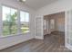 Bright room with hardwood floors, large windows, and white trim, offering ample natural light at 7108 Hambright Rd, Huntersville, NC 28078