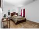 Comfortable bedroom featuring a wood bed frame, wood floors, and bright natural light at 7138 Somerset Springs Dr, Charlotte, NC 28262