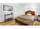 Bright bedroom features a wood bed frame, wood floors, and white walls at 7138 Somerset Springs Dr, Charlotte, NC 28262