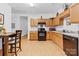 Spacious kitchen with wooden cabinets, updated appliances, and tile flooring at 7138 Somerset Springs Dr, Charlotte, NC 28262