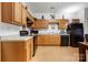 Open kitchen featuring oak cabinetry, black appliances, and laminate floors at 7138 Somerset Springs Dr, Charlotte, NC 28262