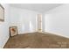 Bright room featuring neutral walls and carpet, providing a blank canvas at 7138 Somerset Springs Dr, Charlotte, NC 28262