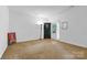 Open living space with neutral walls and carpet, ideal for customization at 7138 Somerset Springs Dr, Charlotte, NC 28262