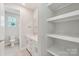 Bright bathroom featuring shelving, a toilet and a vanity with sink at 720 Flare Dr, Tega Cay, SC 29708