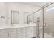 Modern bathroom with double vanity, sleek mirrors, and a glass enclosed shower at 720 Flare Dr, Tega Cay, SC 29708