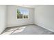 Bedroom with neutral carpeting and a large window overlooking trees at 720 Flare Dr, Tega Cay, SC 29708
