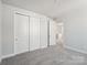 Bedroom with neutral carpeting, double door closet and white trim at 720 Flare Dr, Tega Cay, SC 29708