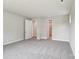 Bedroom with neutral carpeting, ensuite bathroom and a walk-in closet at 720 Flare Dr, Tega Cay, SC 29708