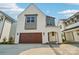 Bright, modern home with a two-car garage and inviting entry way features a beautiful, painted brick facade at 720 Flare Dr, Tega Cay, SC 29708