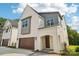 Bright, modern home with a two-car garage and inviting entry way features a beautiful, painted brick facade at 720 Flare Dr, Tega Cay, SC 29708