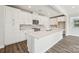 Bright, white eat-in kitchen features stainless appliances, granite countertops, and stylish backsplash at 720 Flare Dr, Tega Cay, SC 29708