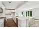 Bright, eat-in kitchen features stainless appliances and stylish backsplash, flowing into the living room with sliding glass doors at 720 Flare Dr, Tega Cay, SC 29708