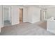 Spacious loft area featuring neutral carpeting, white trim and multiple doorways at 720 Flare Dr, Tega Cay, SC 29708