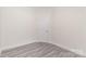 Simple, unfinished bedroom with gray vinyl flooring, white trim and paneled door at 925 4Th St, Statesville, NC 28677
