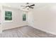 This bright bedroom has two windows, a ceiling fan and neutral walls with vinyl flooring at 925 4Th St, Statesville, NC 28677