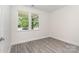 Bedroom with new gray vinyl flooring and a large window looking outside at 925 4Th St, Statesville, NC 28677