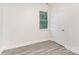 Neutral bedroom with gray vinyl flooring, a window and a paneled door at 925 4Th St, Statesville, NC 28677