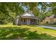 Angle of a cozy home with a well maintained lawn and mature trees at 925 4Th St, Statesville, NC 28677