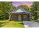 Charming single-story home with gray siding, a covered front porch, and a well-manicured lawn at 925 4Th St, Statesville, NC 28677