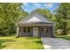 Charming single-story home with gray siding, a covered front porch, and a well-manicured lawn at 925 4Th St, Statesville, NC 28677