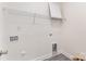 A compact laundry room with essential hookups and a wire rack shelf at 925 4Th St, Statesville, NC 28677